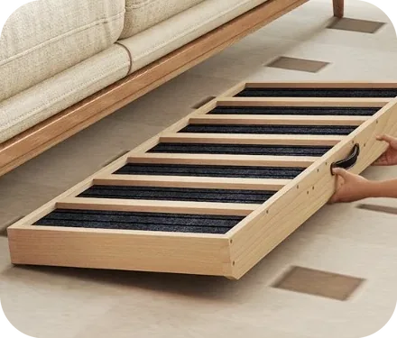 The folded ramp sliding flat under a sofa