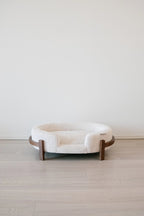 The Chic Henley Dog Bed in Sandstone, front view showing the low entry and the bolster walls