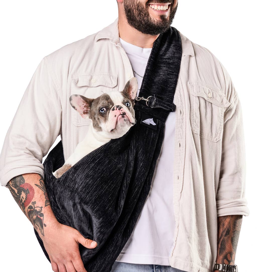 Sierra Sling pet carrier in Black, worn with a French bulldog inside